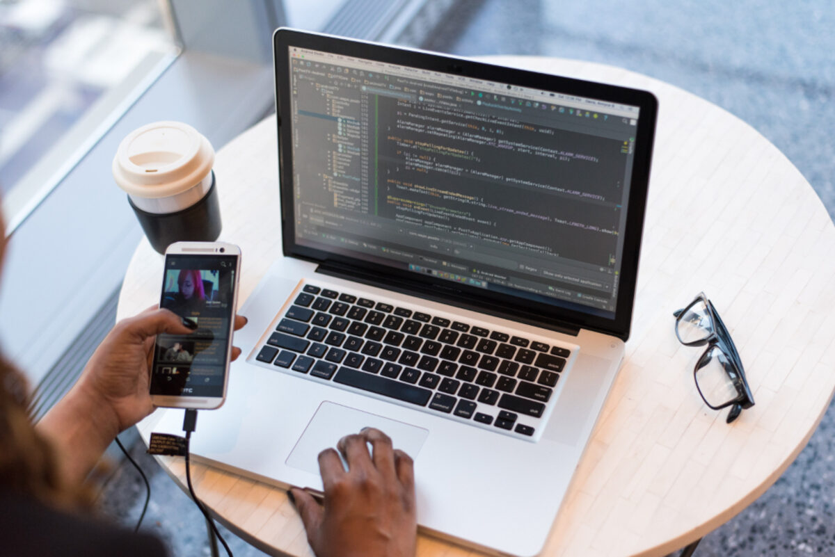 Business owner reviewing their new website on a laptop and phone
