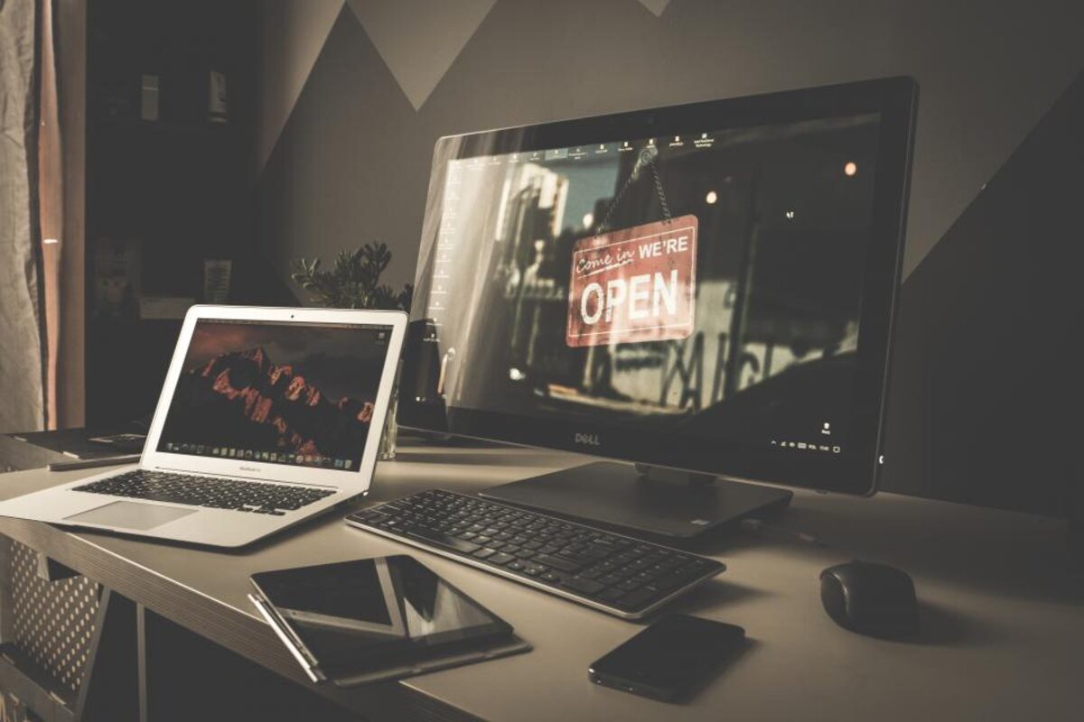 A small business website shown on a desktop monitor and laptop